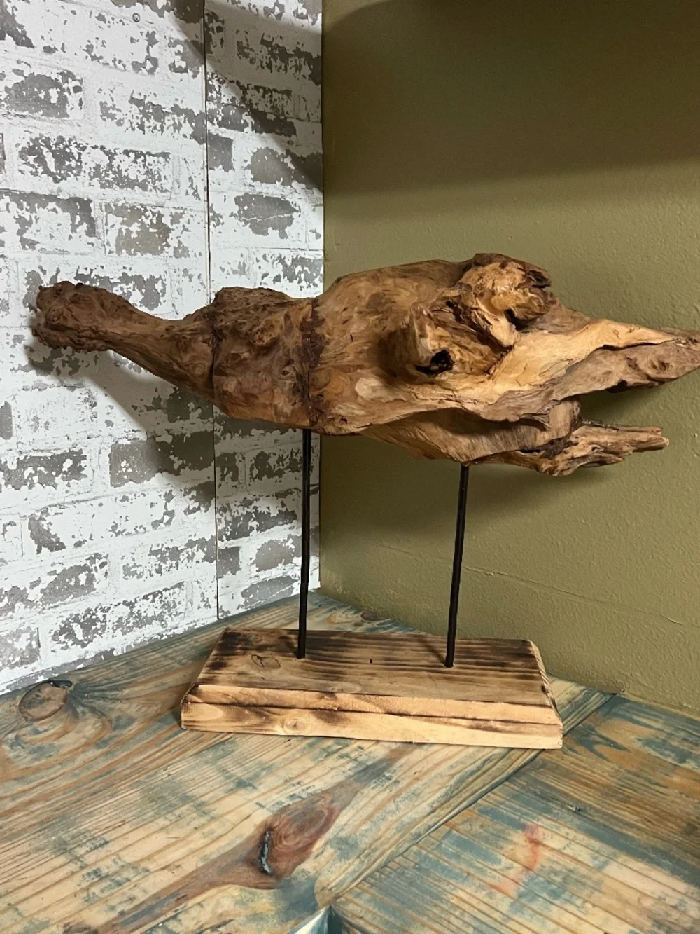 Natural weathered wood teak root rustic tabletop art piece supported by metal